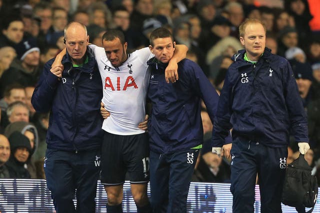 Andros Townsend is helped from the White Hart Lane pitch but his injury is not as bad as first feared 