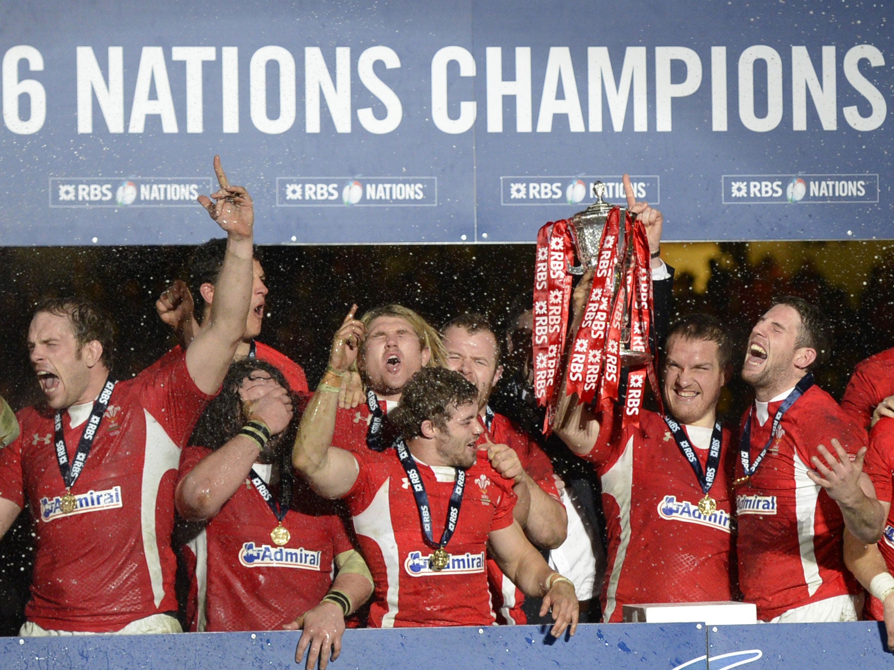 Wales players celebrate after winning the Six Nations international rugby union match between Wales and England and the Six Nations championship at the Millennium Stadium in Cardiff, south Wales
