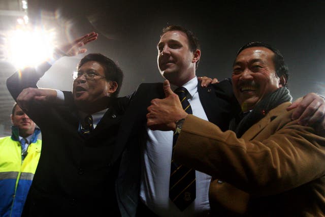 Vincent Tan (right) in happier times with Malky Mackay (centre) as they celebrate a Cardiff victory 
