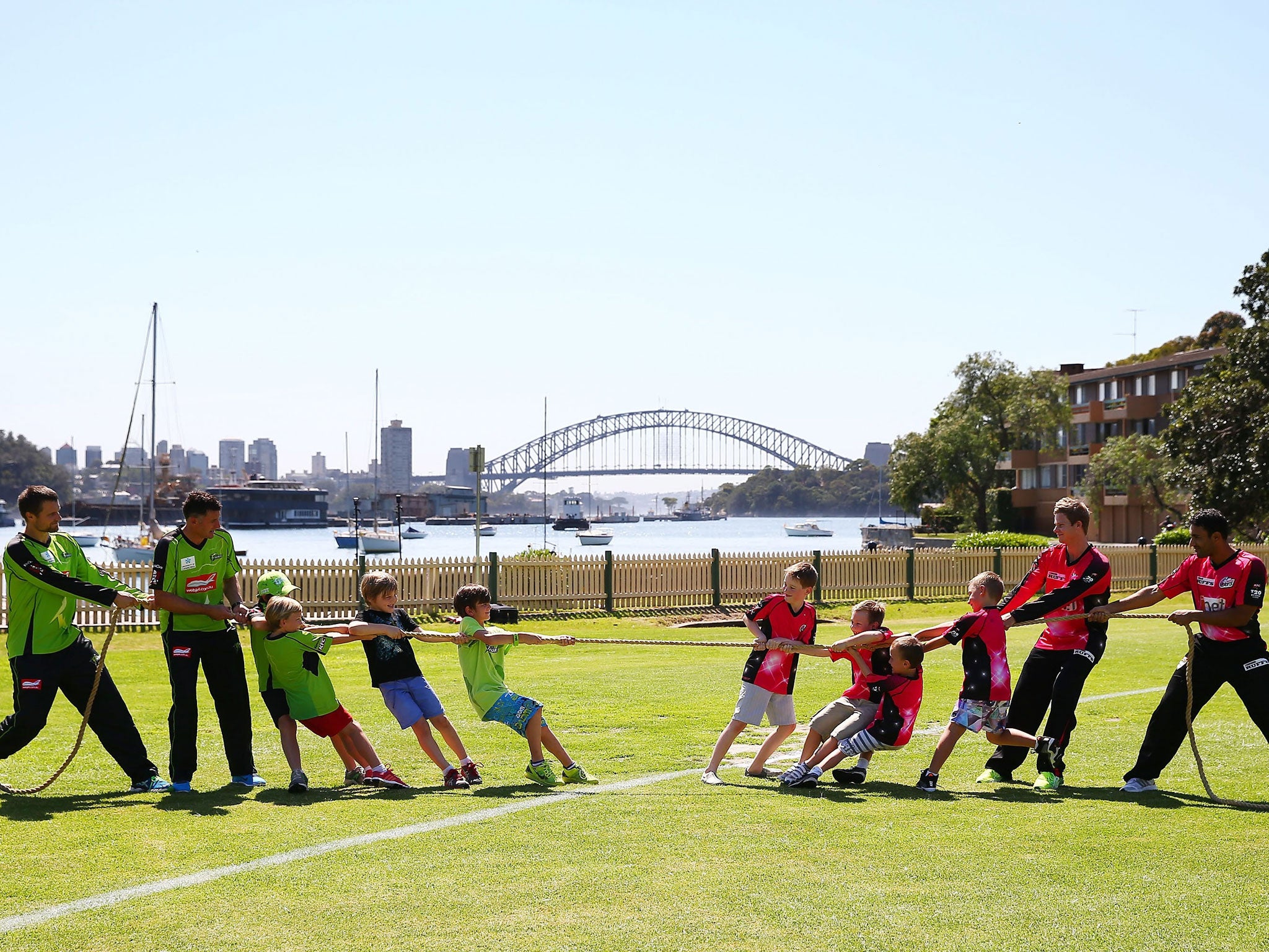 Mike Hussey and Dirk Nannes, of the Sydney Thunder (left), and young fans test the pull of the Big Bash League against Sydney Sixers' Steve Smith and Ravi Bopara