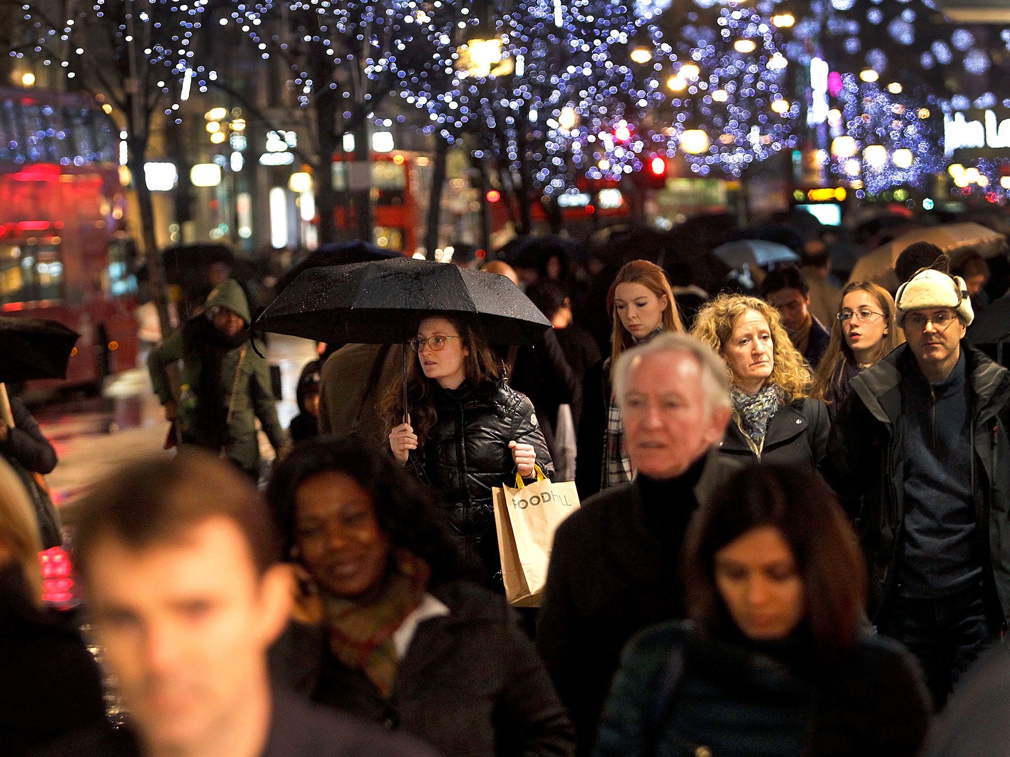 Christmas Shoppers brave rain and thunder storms to hunt for gifts at Oxford Circus