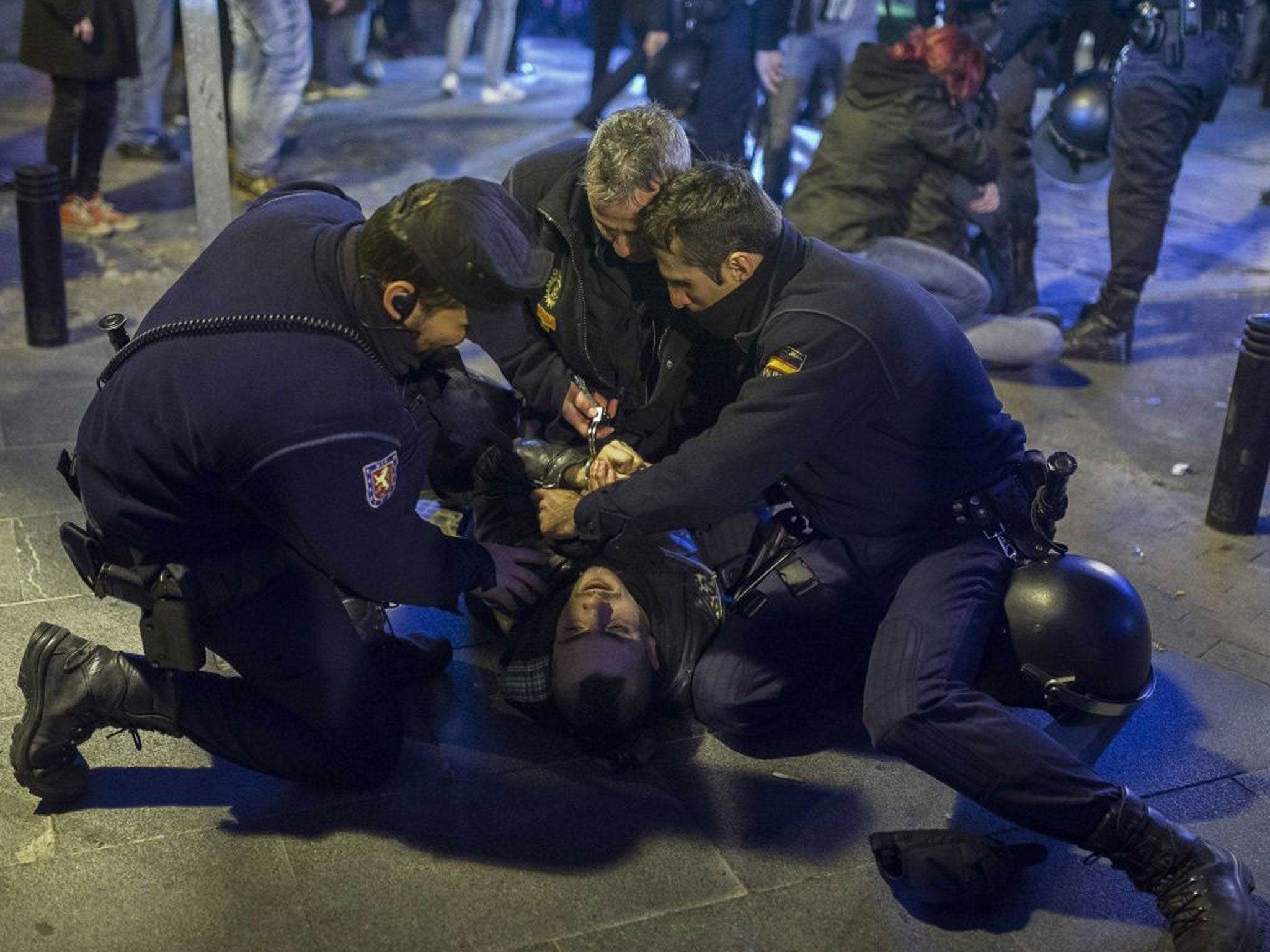 Riot policemen arrest a demonstrater during a protest against government over issues of abortion in Madrid, Spain, Friday, 20 2013.