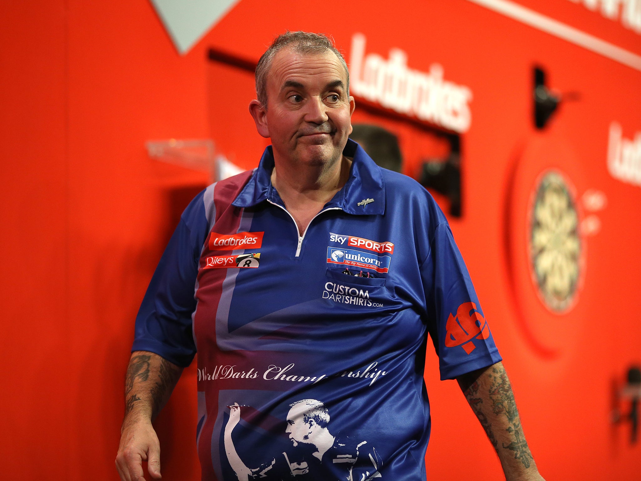Phil Taylor walks off stage after he's beaten by Michael Smith in the Darts World Championship