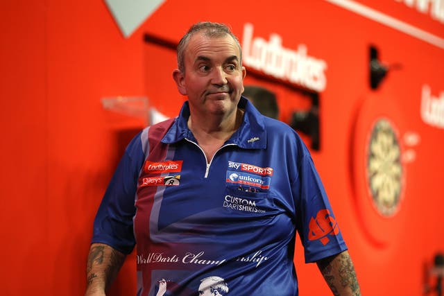 Phil Taylor walks off stage after he's beaten by Michael Smith in the Darts World Championship