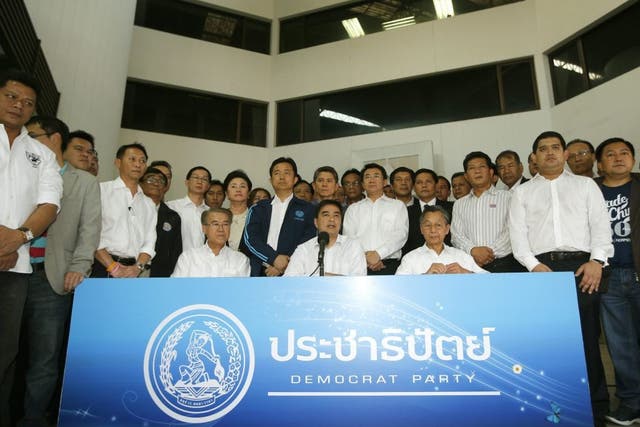 Thai opposition Democrat Party's leader Abhisit Vejjajiva (front C) and members party, speaks to media during a press conference at the party headquarters in Bangkok, Thailand, 21 December 2013. 