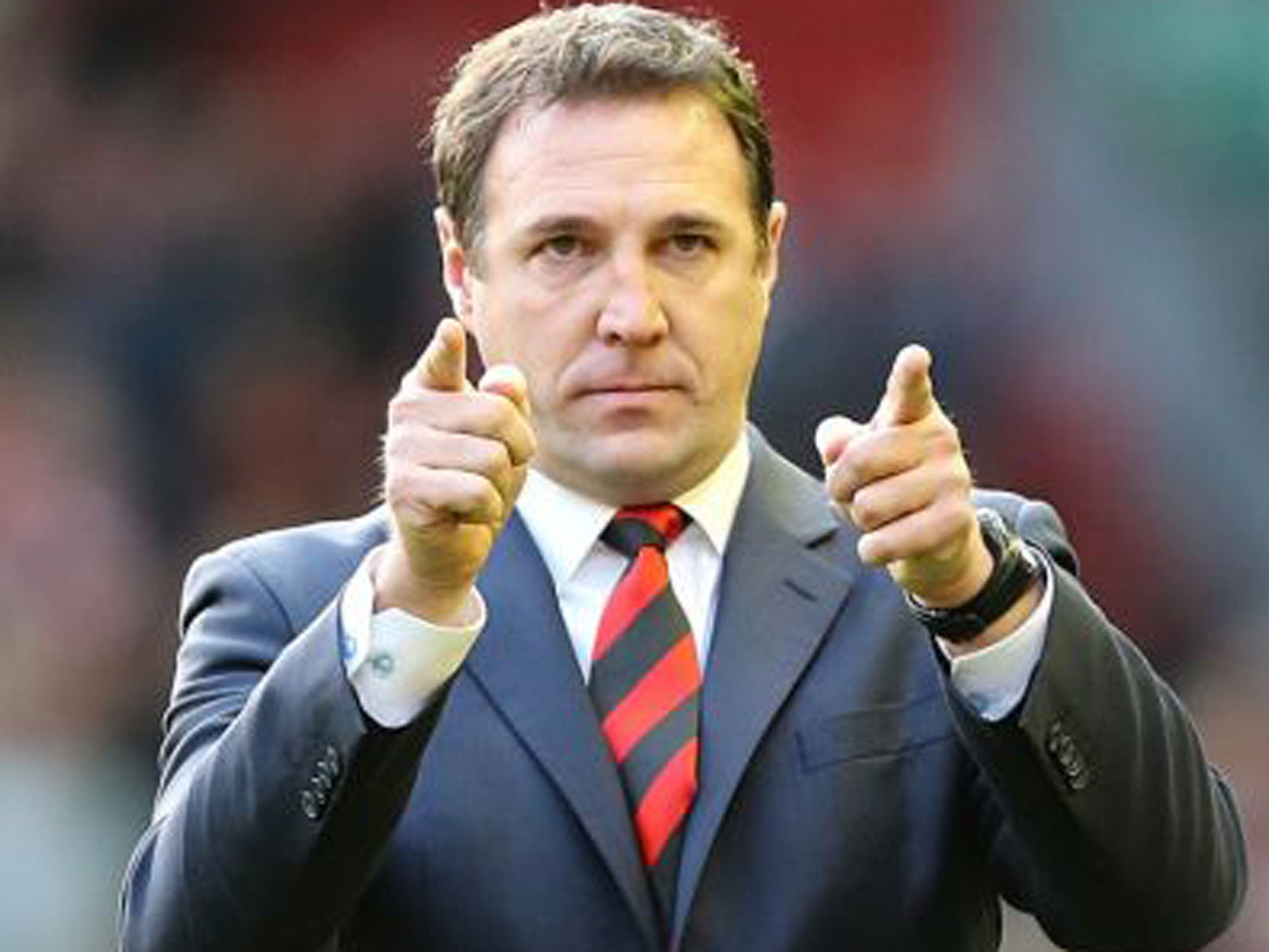 Malky Mackay salutes the Cardiff fans after the 3-1 defeat at Liverpool on Sunday