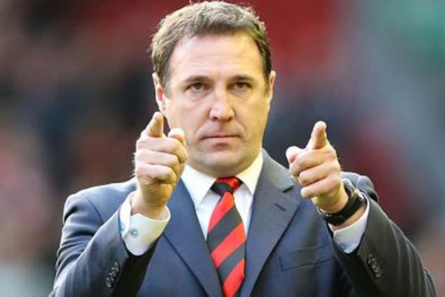 Malky Mackay salutes the Cardiff fans after the 3-1 defeat at Liverpool on Sunday