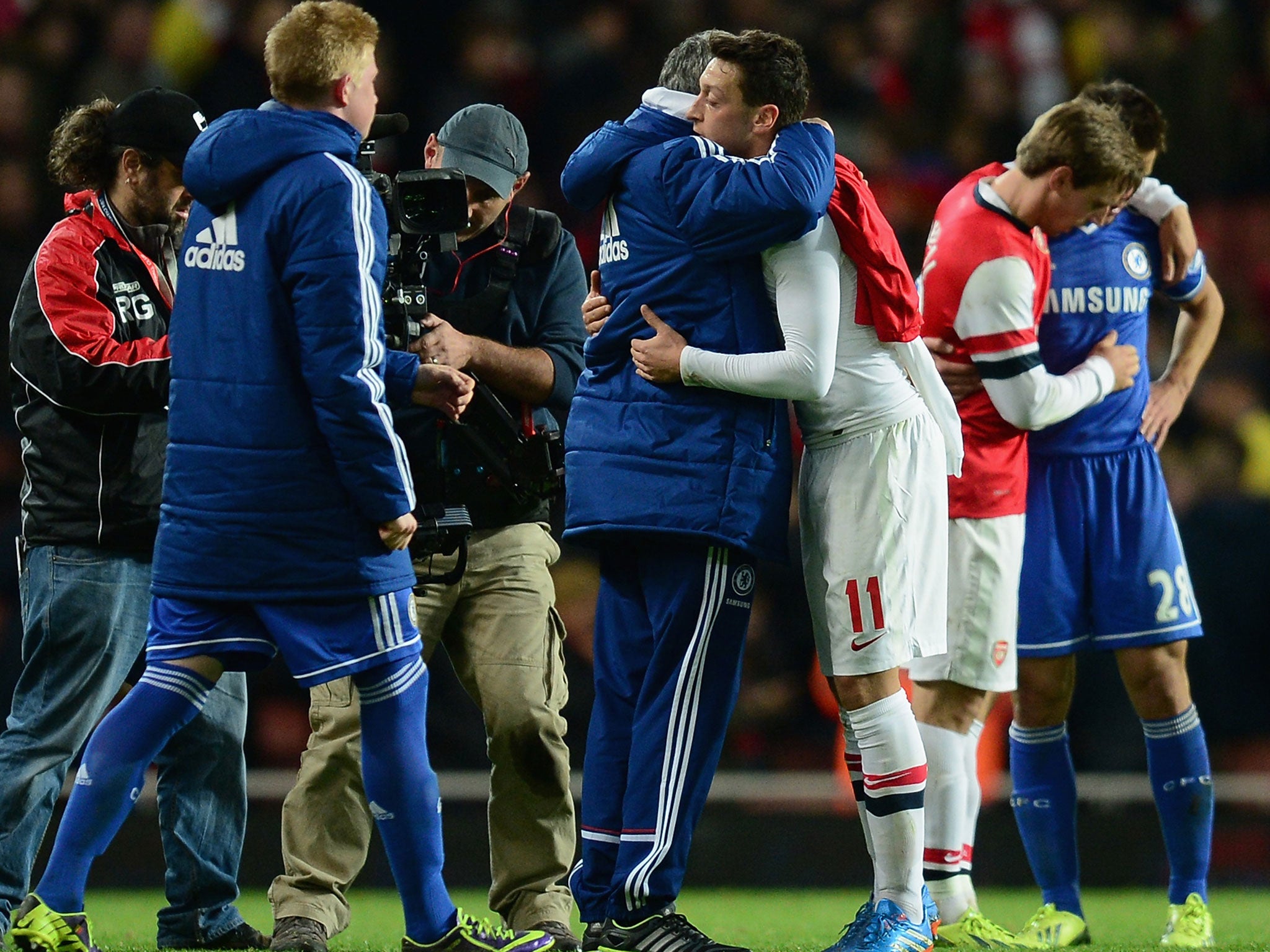 Jose Mourinho and Mesut Ozil embrace (centre) after Chelsea's 2-0 League Cup win over Arsenal in October