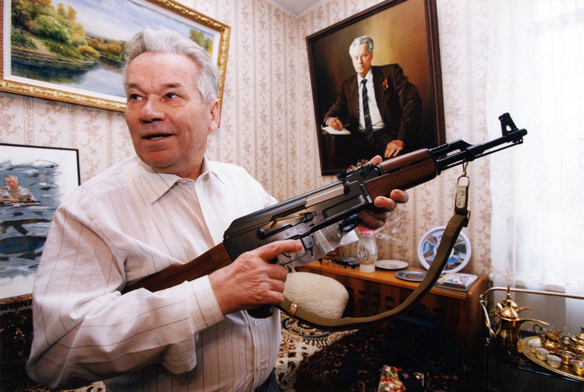 MIKHAIL KALASHNIKOV WITH AN AK-47 RIFLE