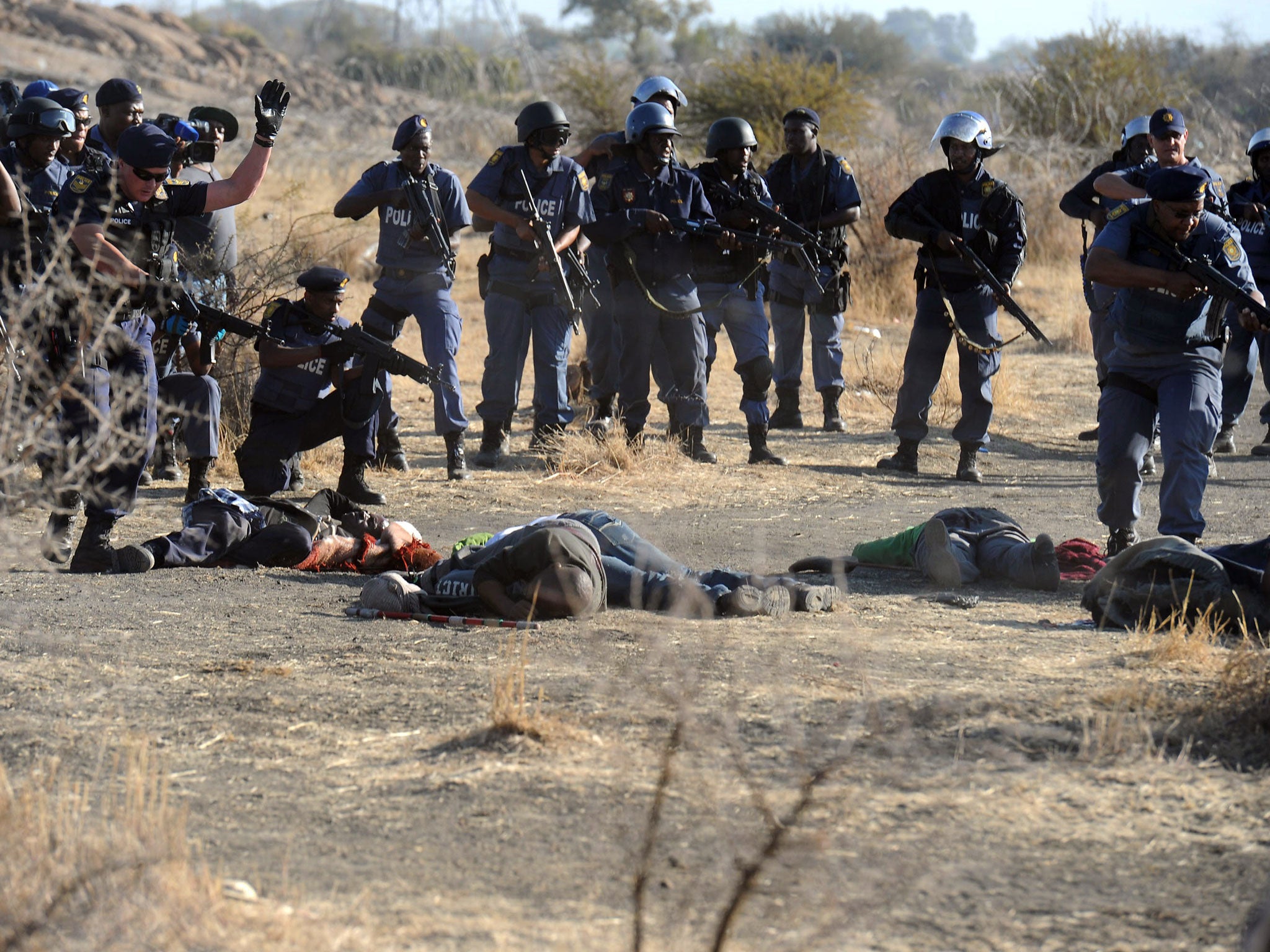 Police surround fallen miners after violent clashes near a platinum mine in Marikana in August last year. A commission of inquiry has said it feels it may not be being told the truth