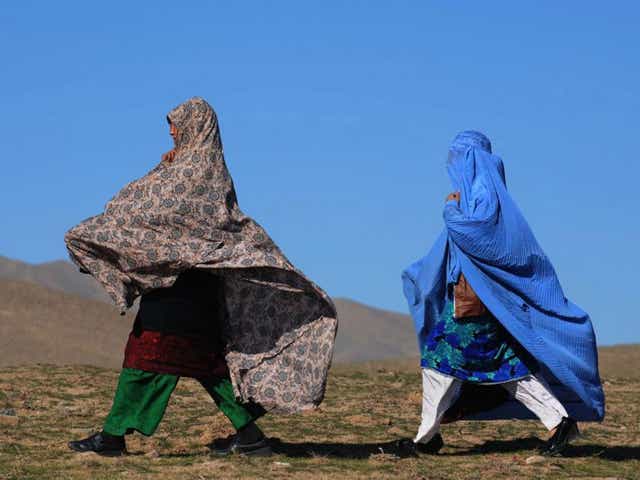 Afghan residents walk to receive winter blankets during a relief distribution programme in Herat. Decades of conflict have left Afghanistan with one of the highest internally displaced populations in the world