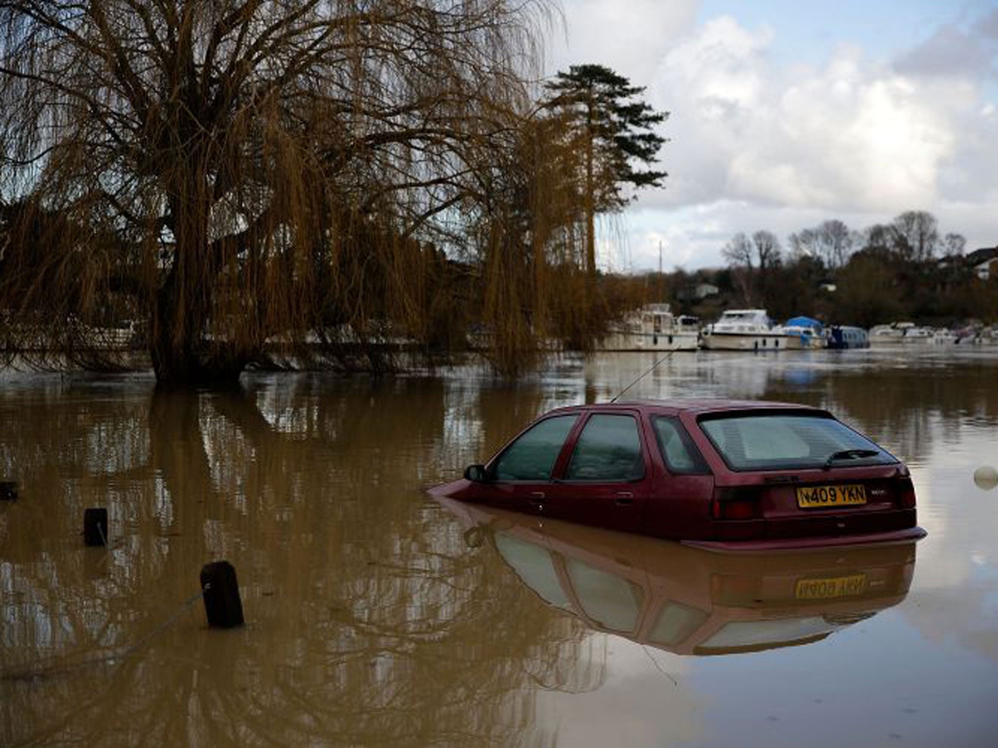 An abandoned vehicle in floodwater yesterday in Tovil