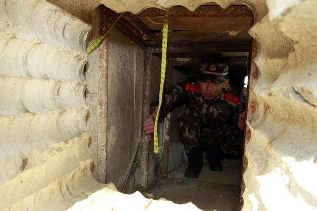 A soldier checking an underground tunnel leading to Hong Kong from Shenzhen, south China's Guangdong province.