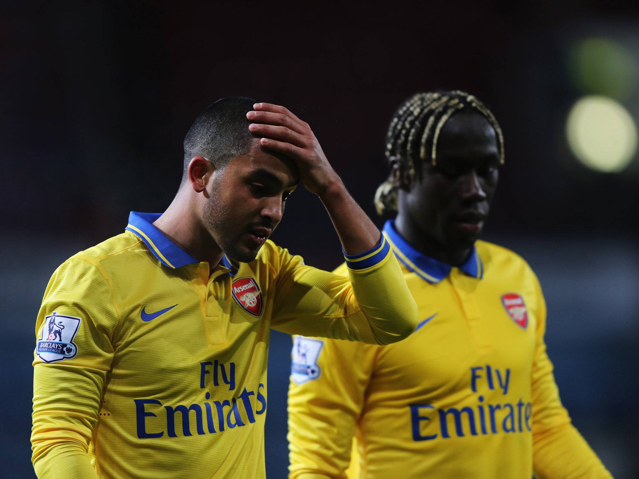 Theo Walcott speaks to teammate Bacary Sagna after his two goals helped Arsenal beat West Ham 3-1