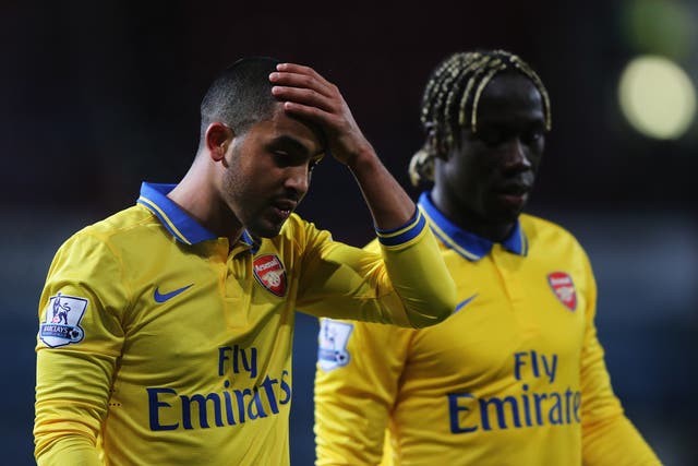 Theo Walcott speaks to teammate Bacary Sagna after his two goals helped Arsenal beat West Ham 3-1