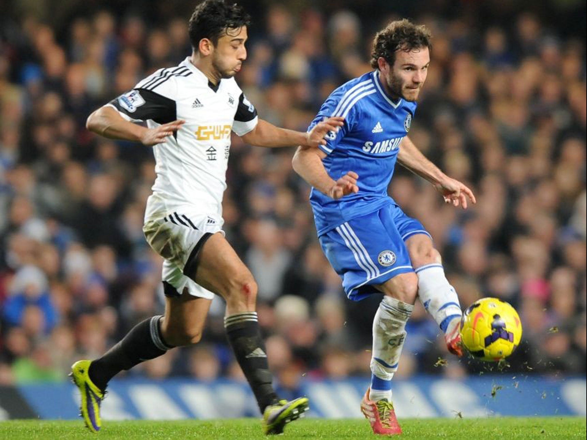Chelsea's Spanish midfielder Juan Mata vies with Swansea City's Welsh defender Neil Taylor (AFP)