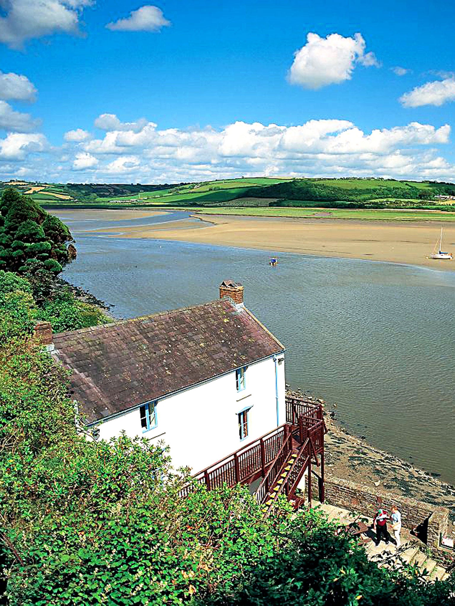 The Laugharne boat house where Dylan Thomas lived and worked in the final years of his life, looking out over the estuary and the trees beyond, which is said to be the inspiration for Under Milk Wood.