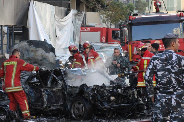 Firefighters put out a blaze after an ex-Lebanese minister was killed in a powerful bomb blast in central Beirut