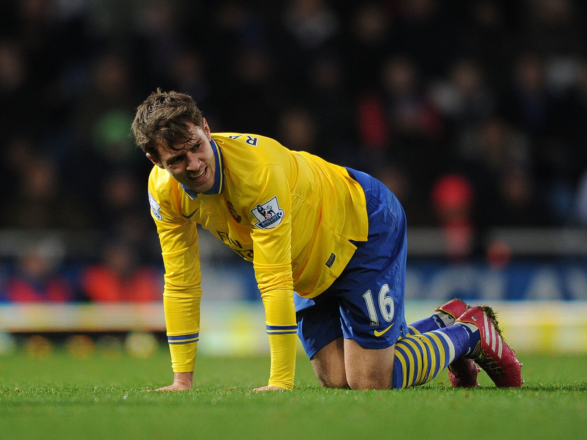 Arsenal midfielder Aaron Ramsey goes down injured in the win at West Ham