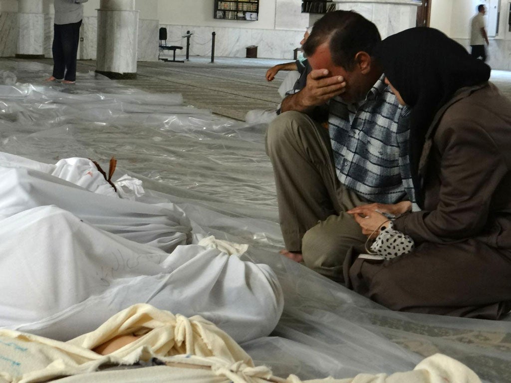 Syrians mourn victims of a poison gas attack in the Damascus suburb of Ghoura