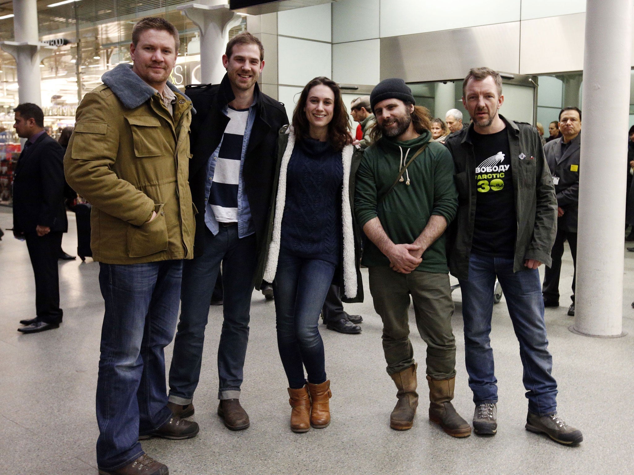 Freelance videographer Kieron Bryan (second left) with Greenpeace activists, Anthony Perrett (left), Alexandra Harris, Iain Rogers and Phil Ball (right), as they arrive at St Pancras Station, London, after being detained in Russia as part of the so-called