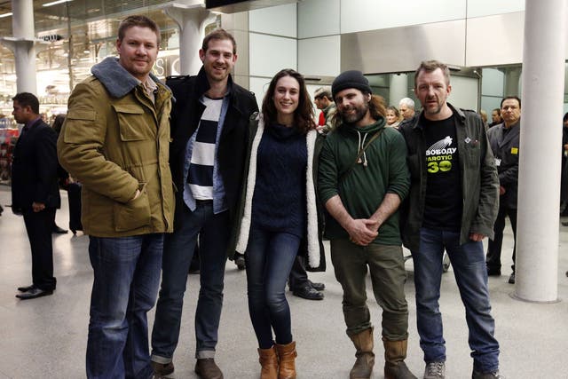 Freelance videographer Kieron Bryan (second left) with Greenpeace activists, Anthony Perrett (left), Alexandra Harris, Iain Rogers and Phil Ball (right), as they arrive at St Pancras Station, London, after being detained in Russia as part of the so-called