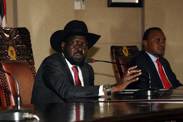 South Sudan President, Salva Kiir, left, sitting with his Kenyan counterpart Uhuru Kenyatta - South Sudan's neighbours threw their weight behind President Salva Kiir, saying they would not accept any bid to overthrow his democratically elected government