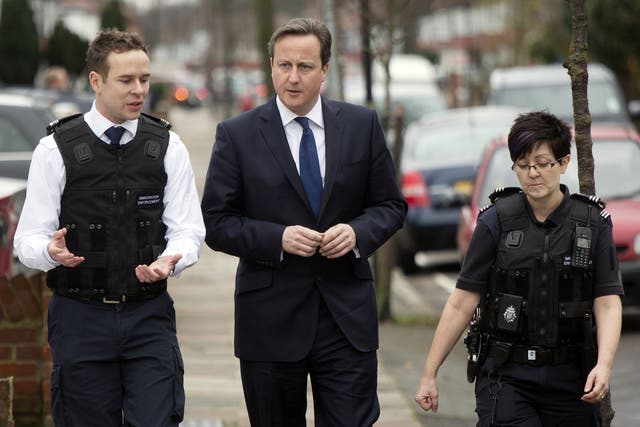 David Cameron visits a house in which was raided by Immigration officers on 18 December. The Prime Minister has been urged to tone down his language when talking about immigration as it is believed to alienate voters