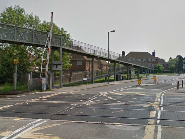 A young woman has died after she was found on fire near this level crossing in New Malden, south-west London this morning