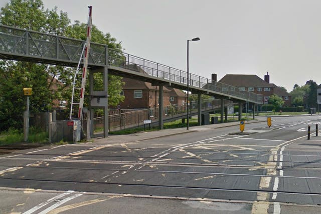 A young woman has died after she was found on fire near this level crossing in New Malden, south-west London this morning