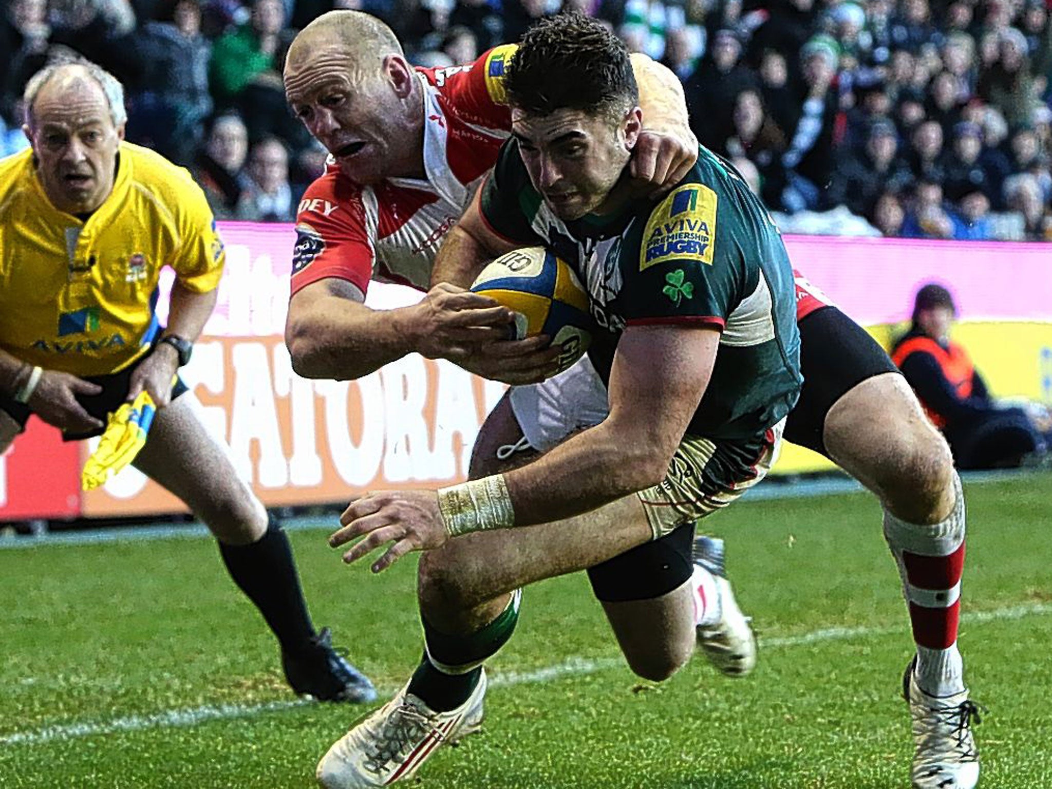 Eamonn Sheridan holds off Gloucester’s Mike Tindall to score his first try for London Irish on Sunday