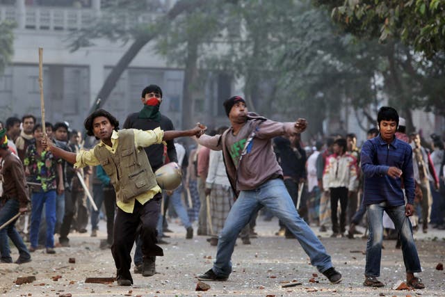 Supporters of the ruling Bangladesh Awami League throw bricks and stones during a clash with the supporters of main opposition Bangladesh Nationalist Party 