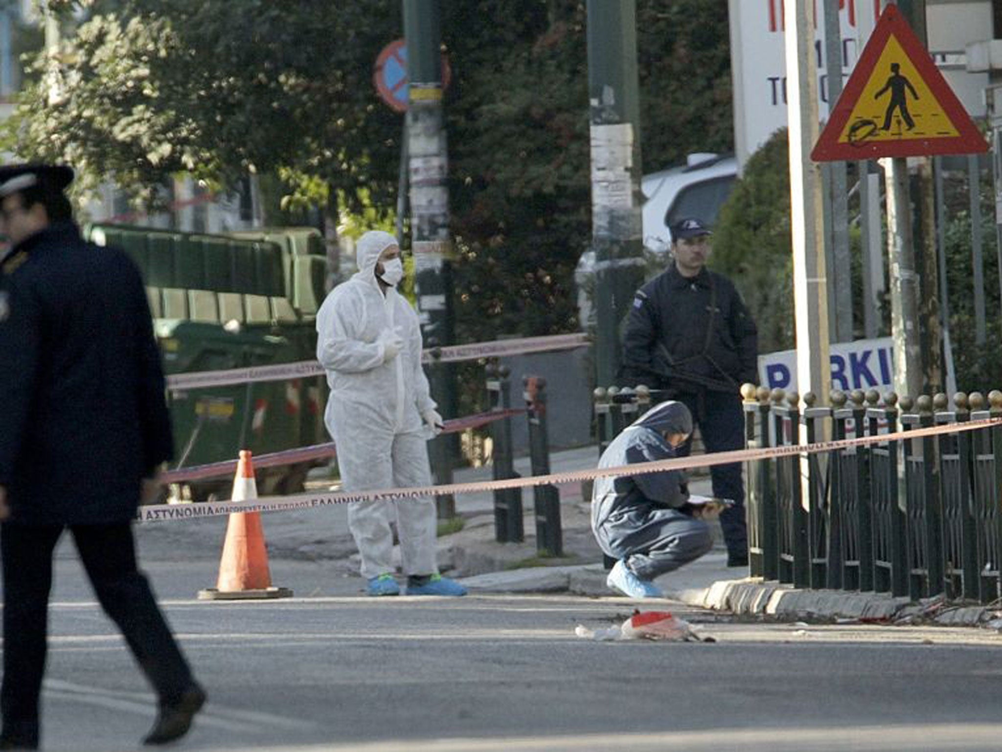 Counter-terrorism officers gather evidence outside the house of the German ambassador Wolfgang Dolt in Athens, Greece