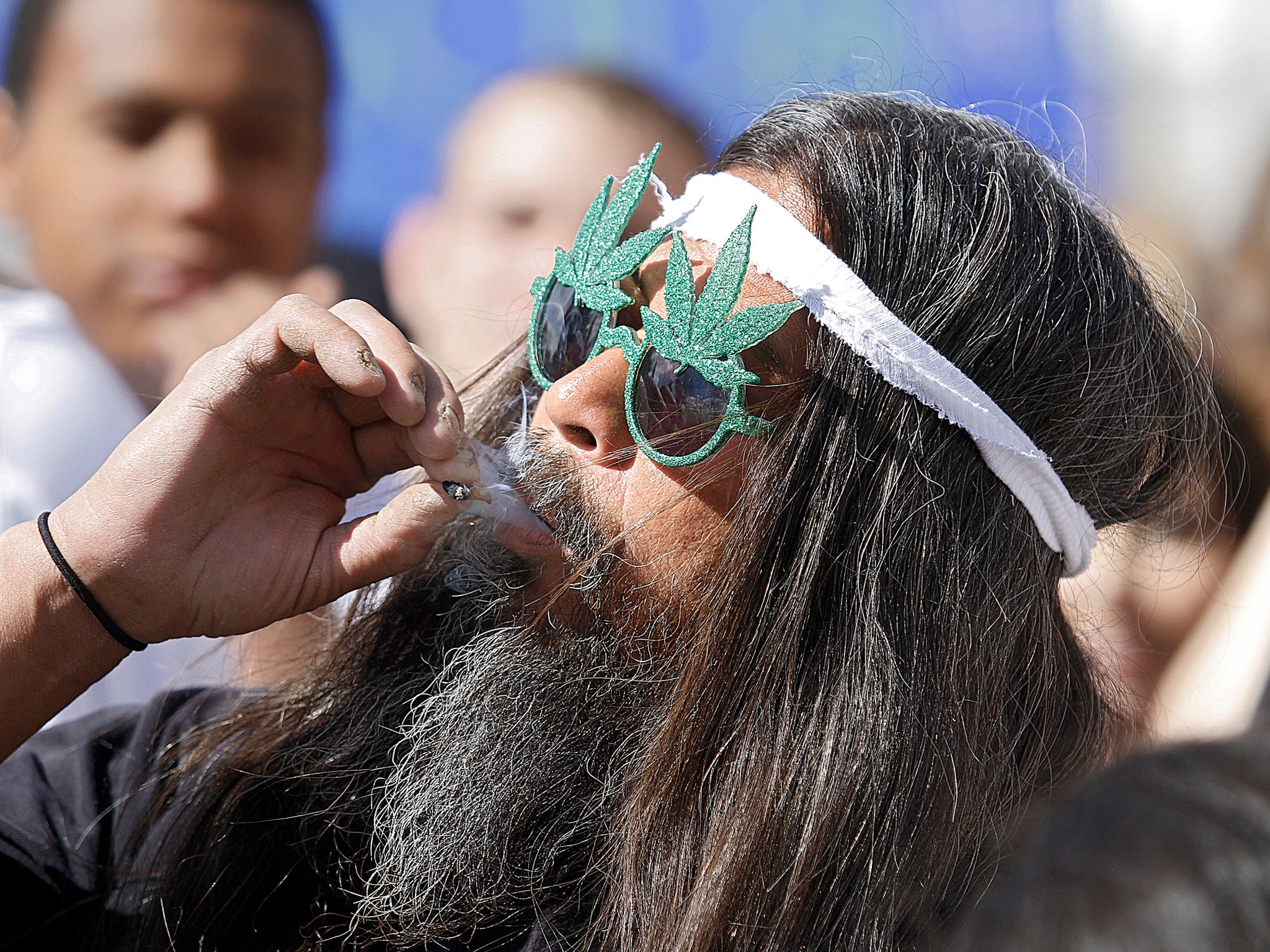A man takes part in a collective cannabis smoking event in Denver, Colorado. Colorado will become the first state to allow the sale of marijuana for recreational use in shops from 1 January 2014
