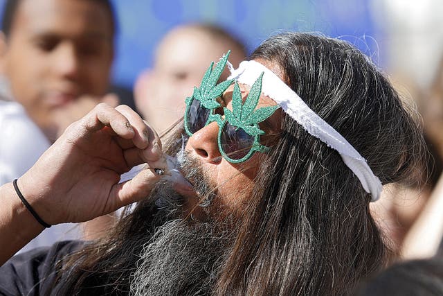 A man takes part in a collective cannabis smoking event in Denver, Colorado. Colorado will become the first state to allow the sale of marijuana for recreational use in shops from 1 January 2014
