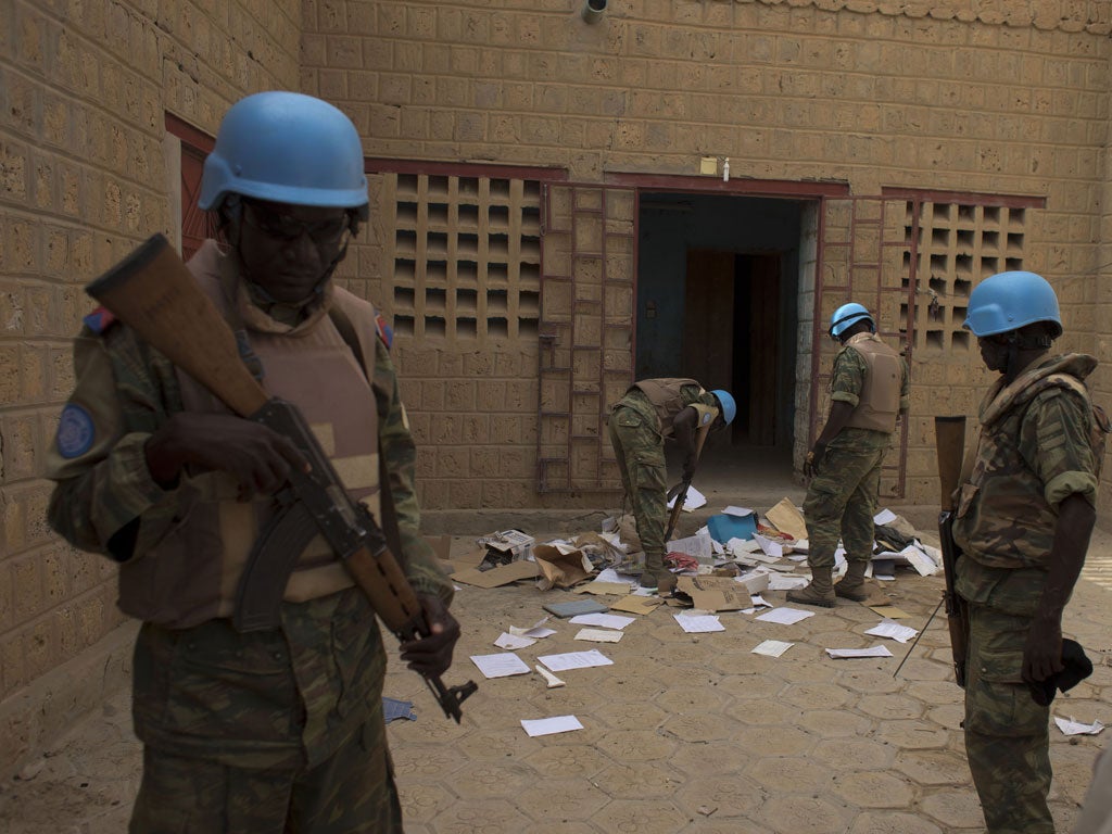 Soldiers look through a cache of al-Qaida documents in Timbuktu