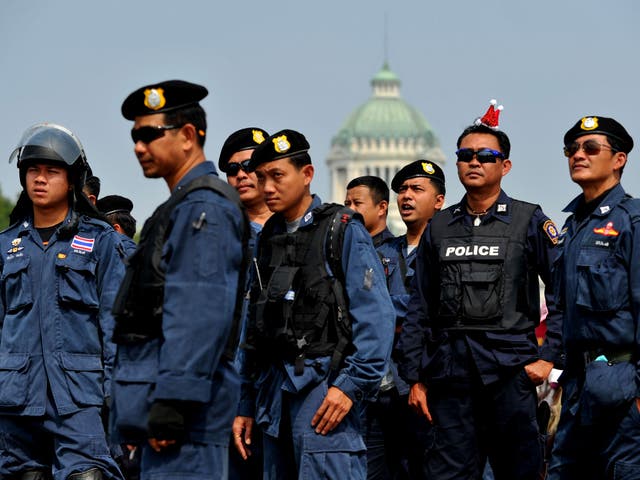 Thai police officers listen as they take part in a peaceful protest at the Royal Plaza in Bangkok 