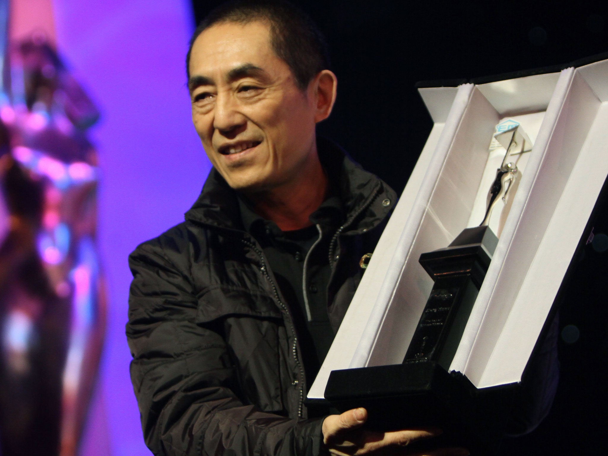 Chinese director Zhang Yimou receives a lifetime achievement award during the closing ceremony of the 35th Cairo International Film Festival
