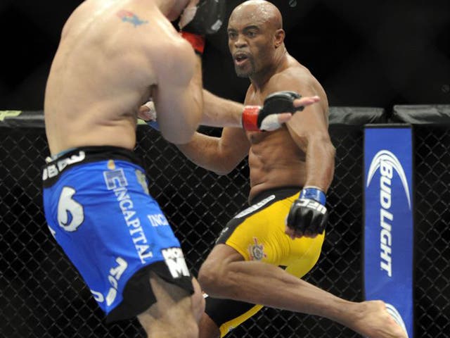 Anderson Silva (right) of Brazil, prepares to kick Chris Weidman during the UFC 168 mixed martial arts middleweight championship bout on Saturday