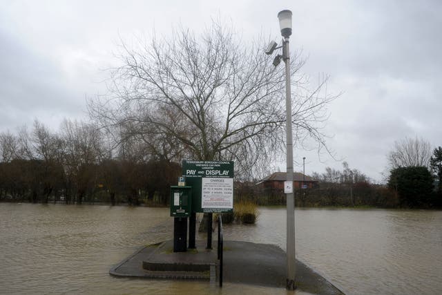 A flooded car park nearTewkesbury Cathedral in Gloucestershire as heavy rain and strong winds continue across the country