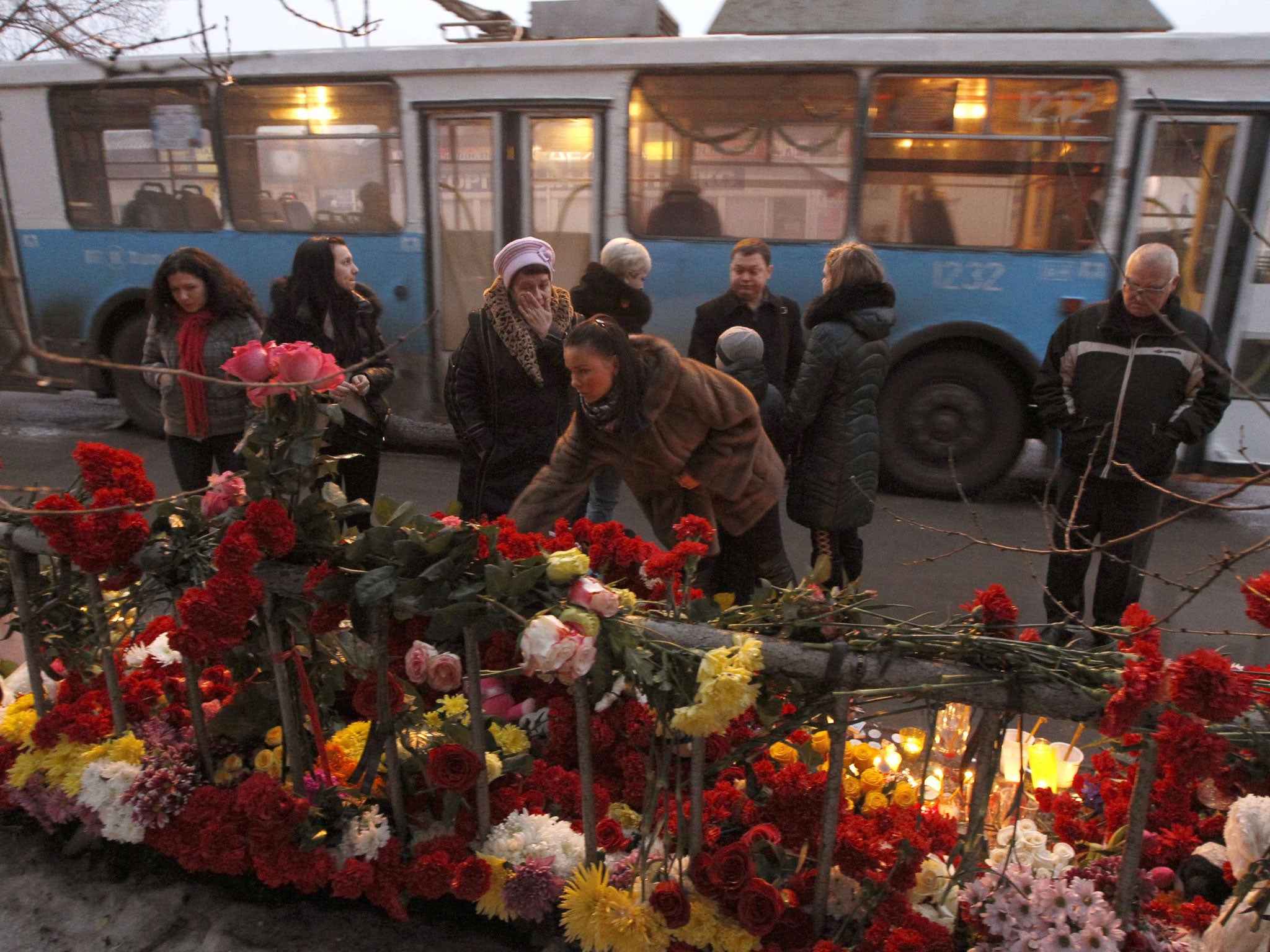 People gather at the site of an explosion on a trolley bus in Volgograd. President Vladimir Putin has vowed to annihilate 'terrorists' following two deadly bomb attacks in less than 24 hours