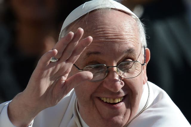 Pope Francis wears his spectacles as he waves to the crowd