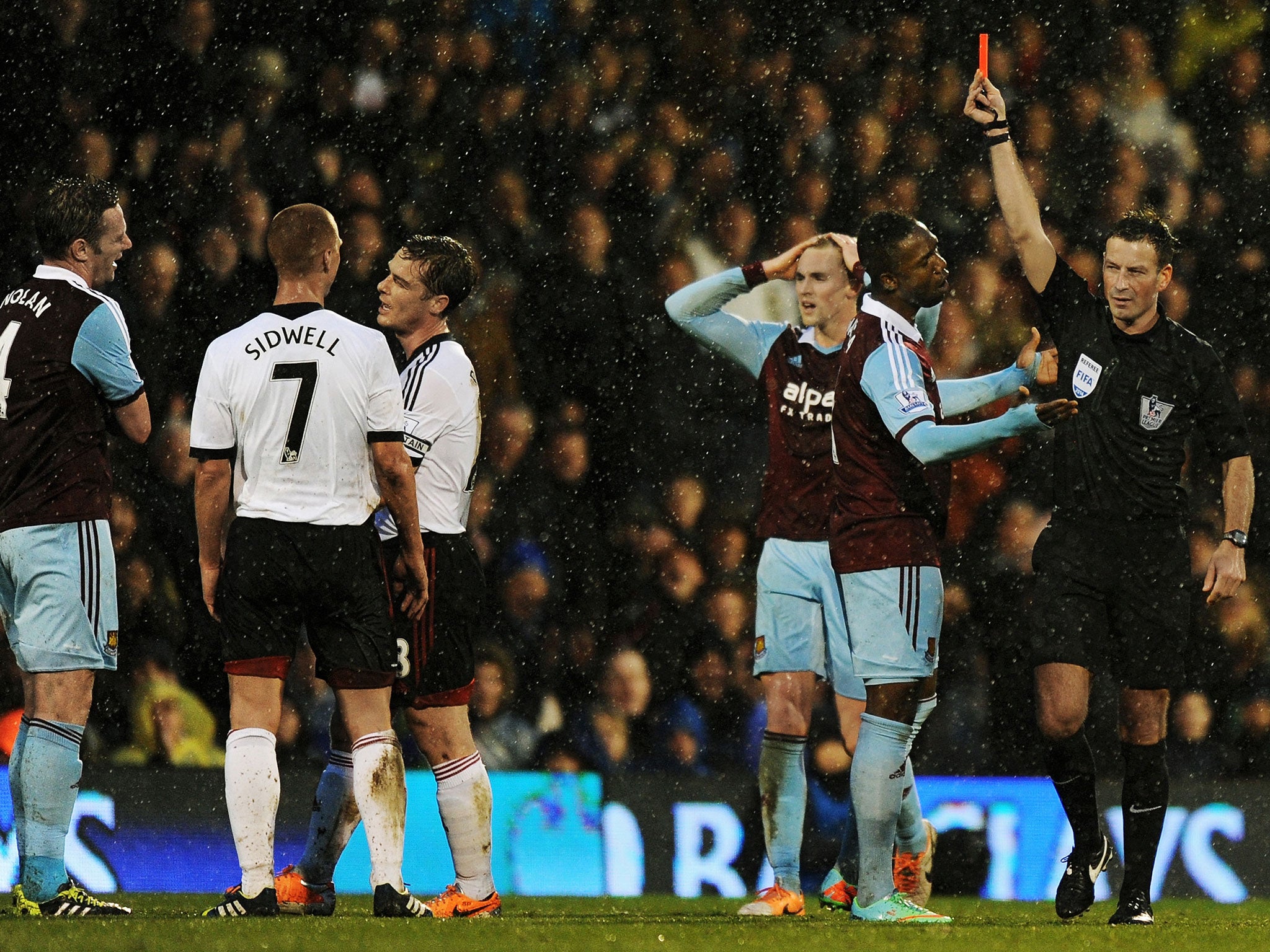 Kevin Nolan (far left) is shown the red card by referee Mark Clattenburg