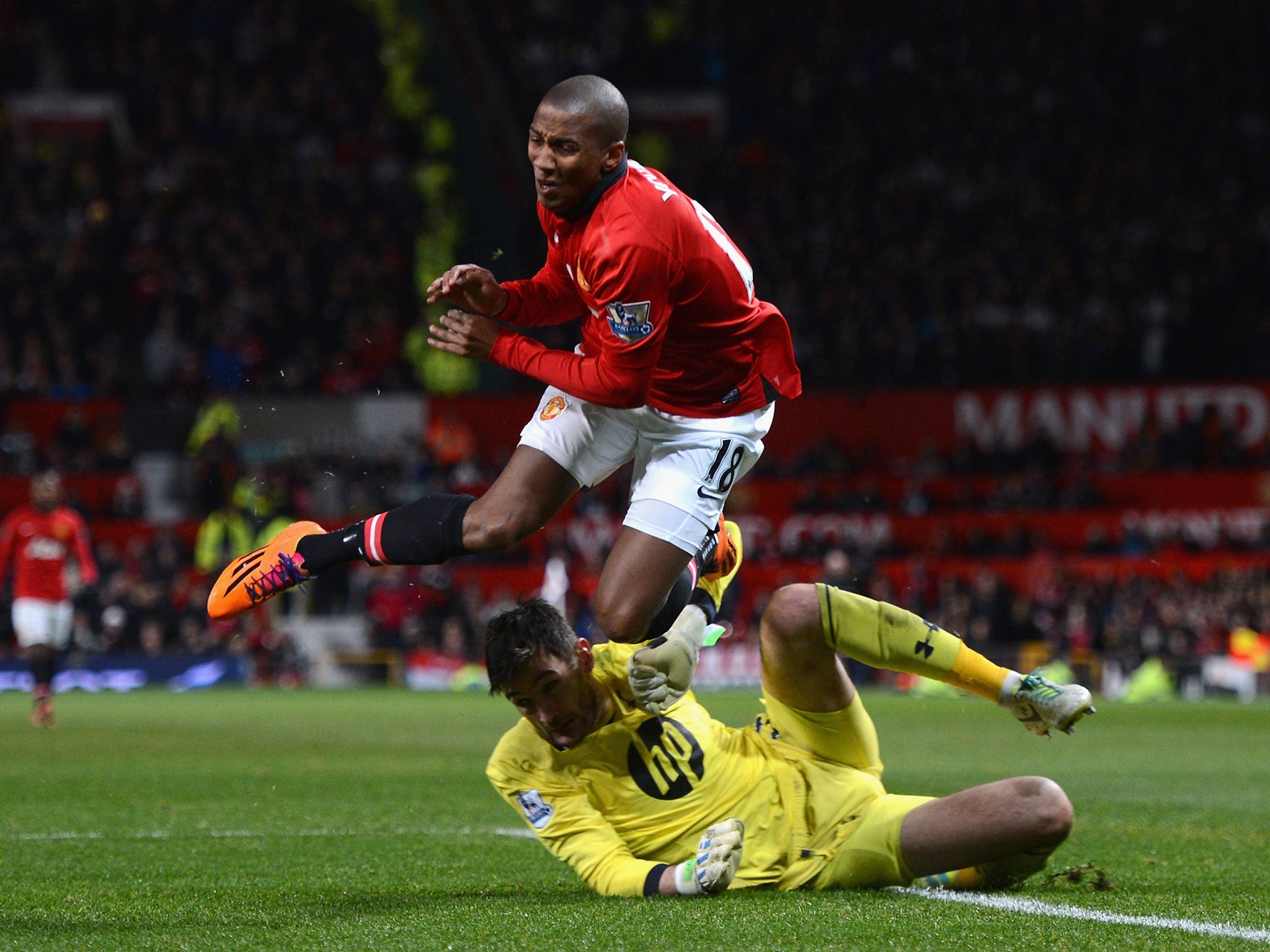 Ashley Young goes down under the challenge of Hugo Lloris, but a penalty was not given