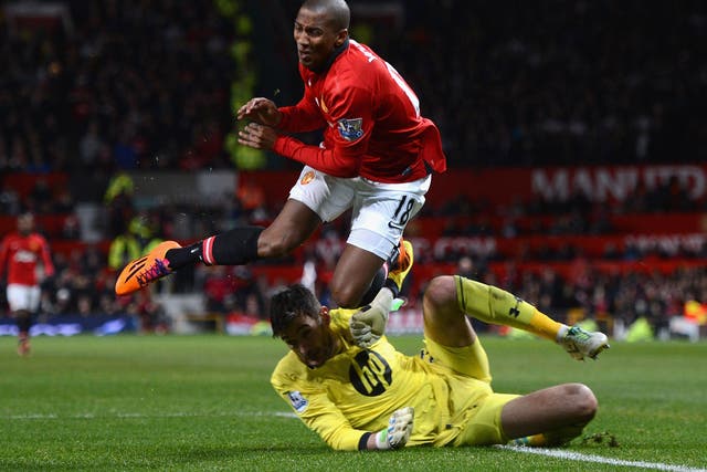 Ashley Young goes down under the challenge of Hugo Lloris, but a penalty was not given