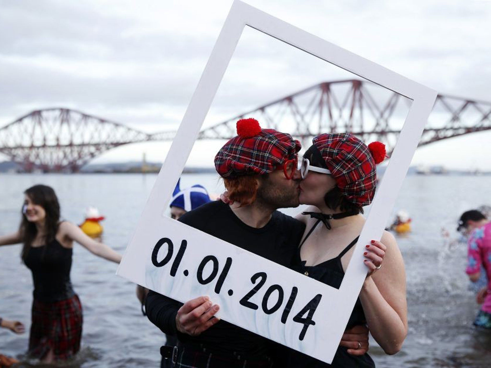Swimmers in fancy dress participate in the New Year's Day Looney Dook swim at South Queensferry, Scotland