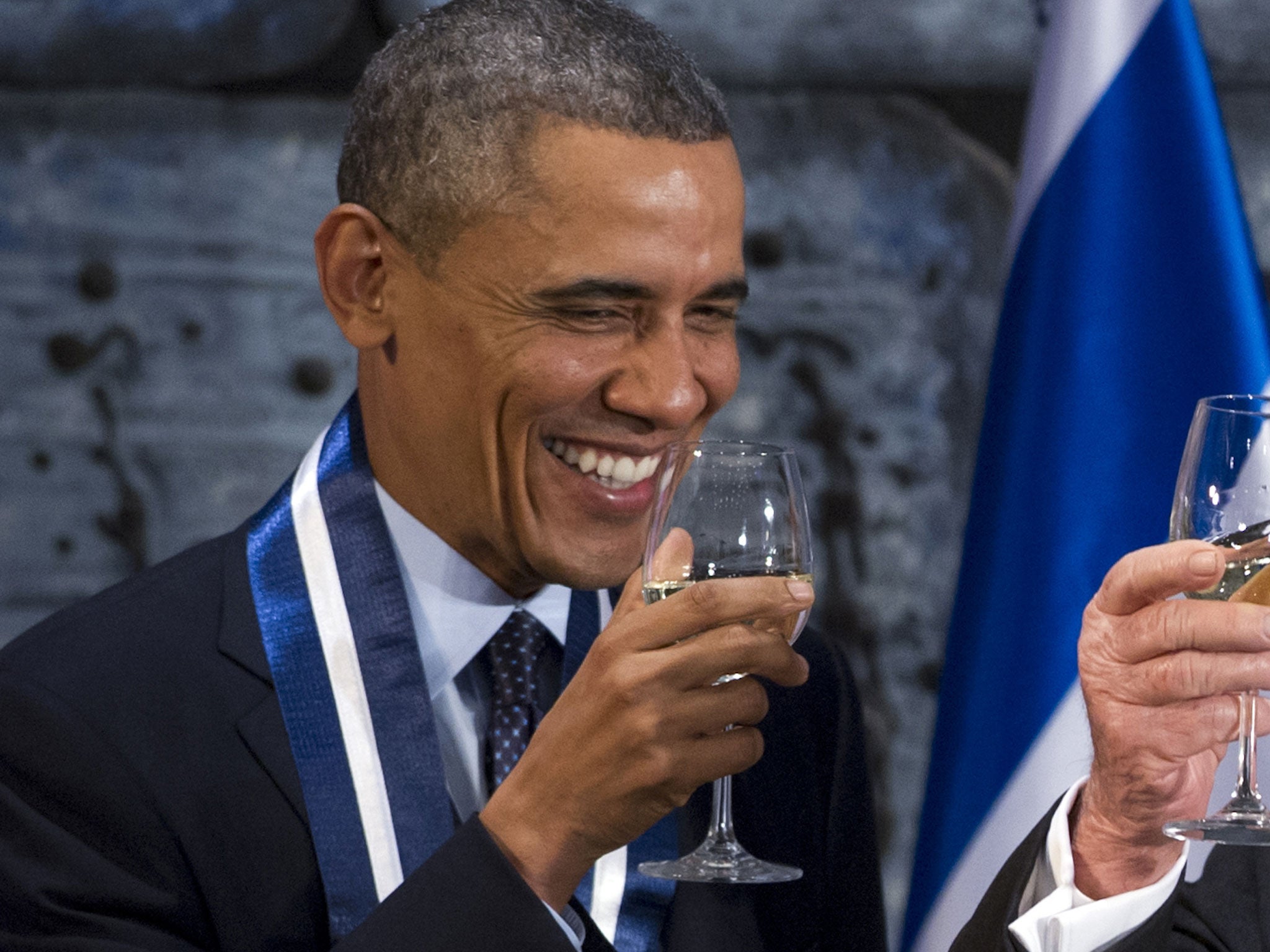 US President and Democrat Barack Obama drinking a glass of white wine