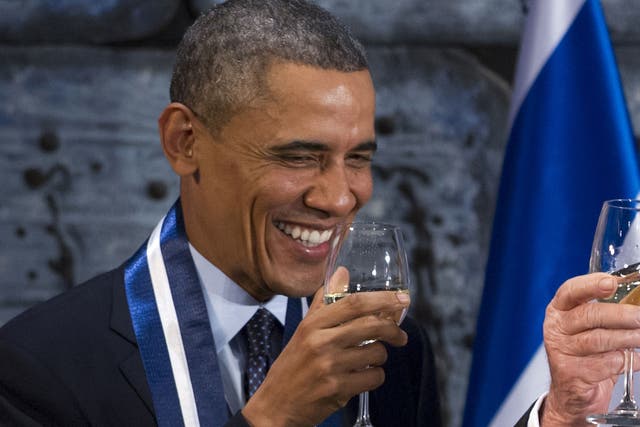 US President and Democrat Barack Obama drinking a glass of white wine 