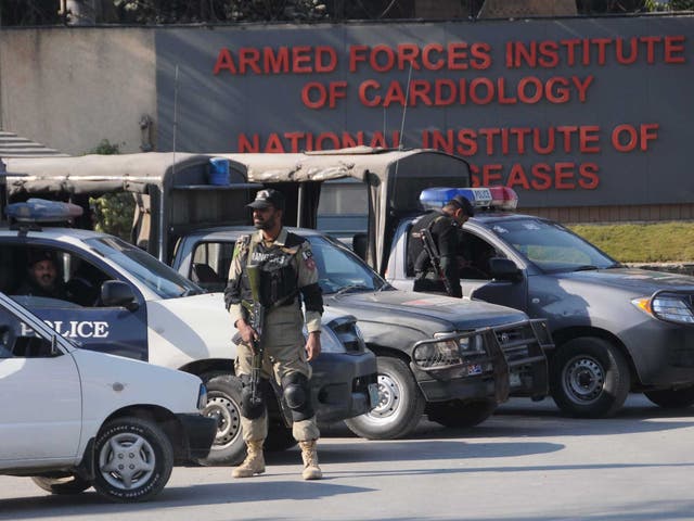 Pakistani security officials stand guard outside the Armed Forces Institute of Cardiology hospital where former President Pervez Musharraf is receiving medical treatment