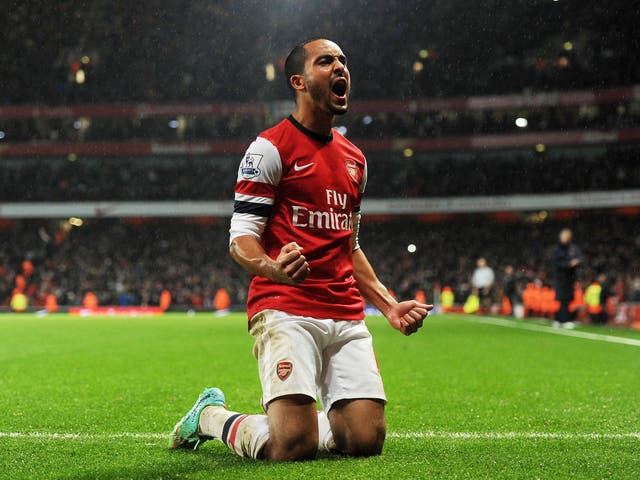 Theo Walcott celebrates a goal against Cardiff City